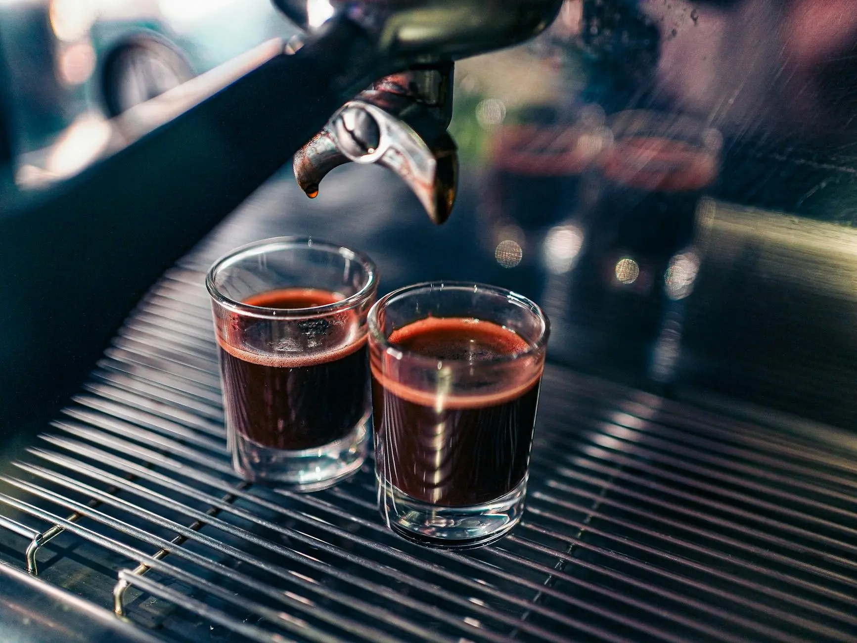 Two freshly brewed espresso shots pouring from a modern coffee machine in Nagpur, India.